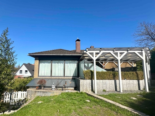 Blick vom Garten auf die überdachte Terrasse