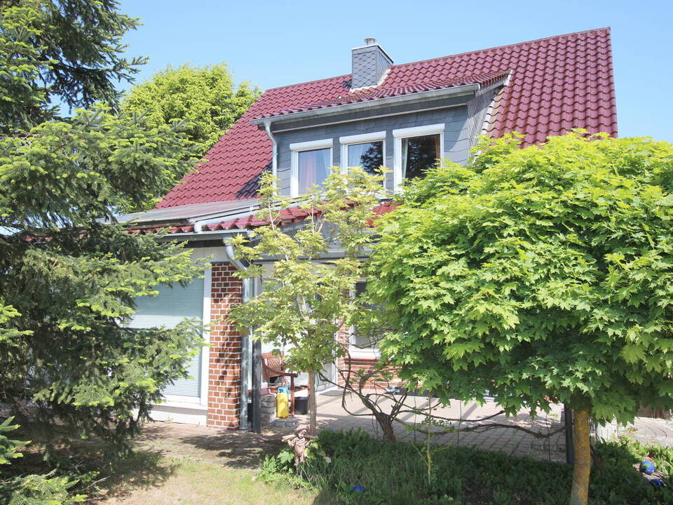 Gartensicht auf Haupthaus mit überdachter Süd-Terrasse u. Wintergarten