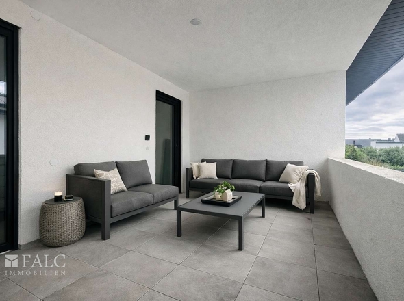 „Großzügige, beheizte Loggia – Boden und Möblierung beispielhaft visualisiert.“