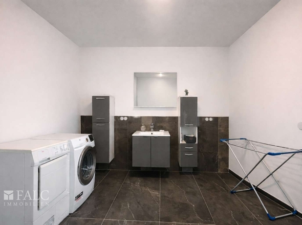 „Funktionaler Technikraum mit integrierter Waschgelegenheit sowie Waschmaschinen- und Trockneranschluss.“