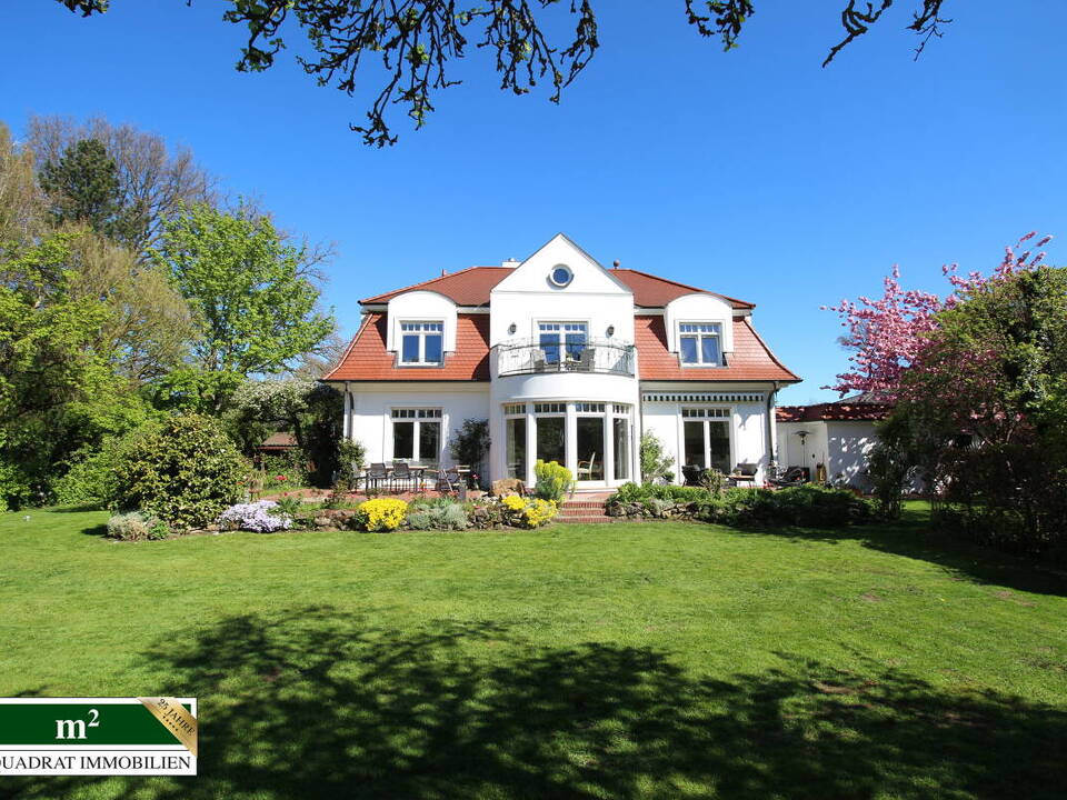Gartenseitiger Blick auf die Villa mit Mansarddach