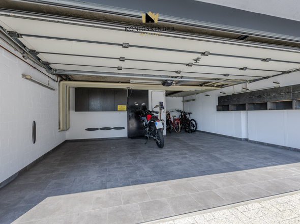 Die reguläre Hausgarage mit Kellerzugang bietet Platz für zwei Autos und Fahrräder.
